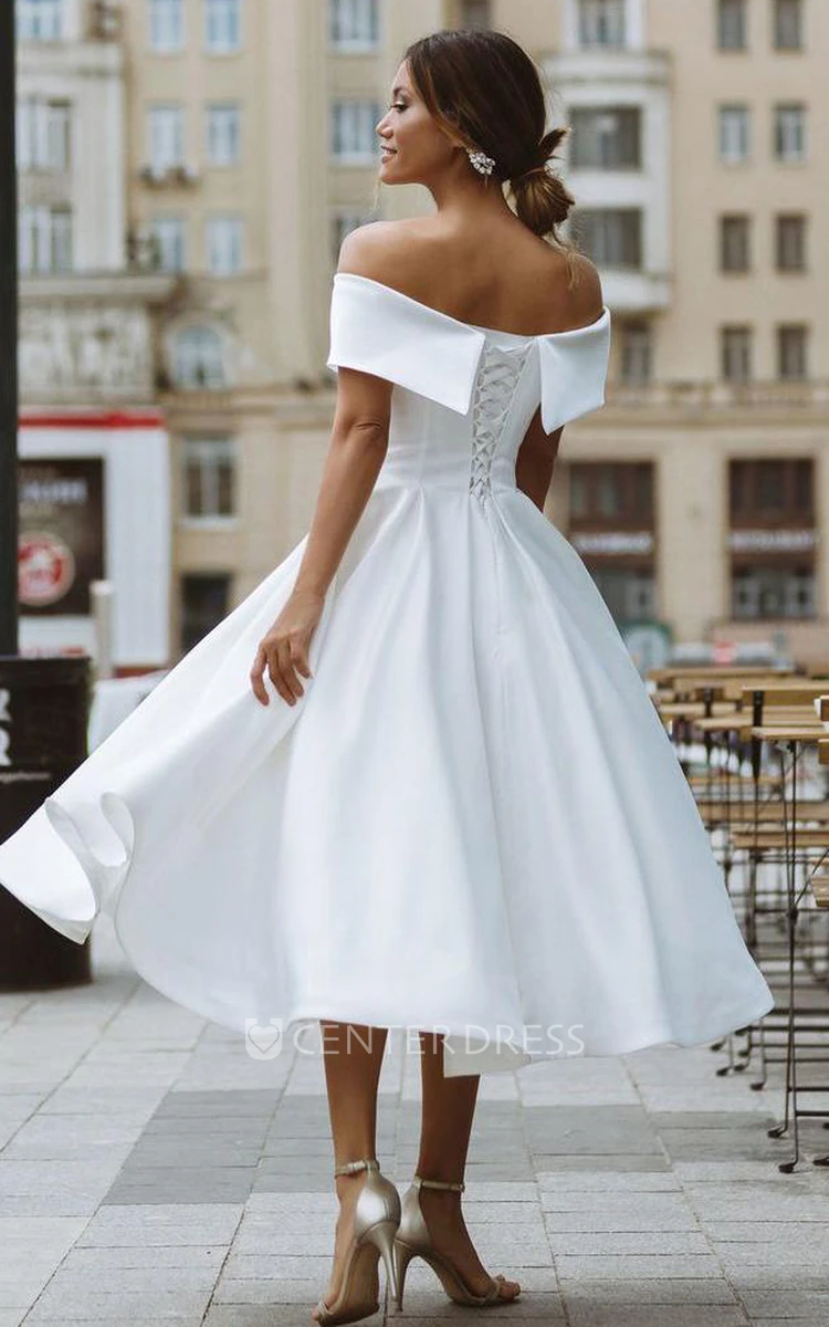 Demure satin tea length wedding dress with long sleeves and lace